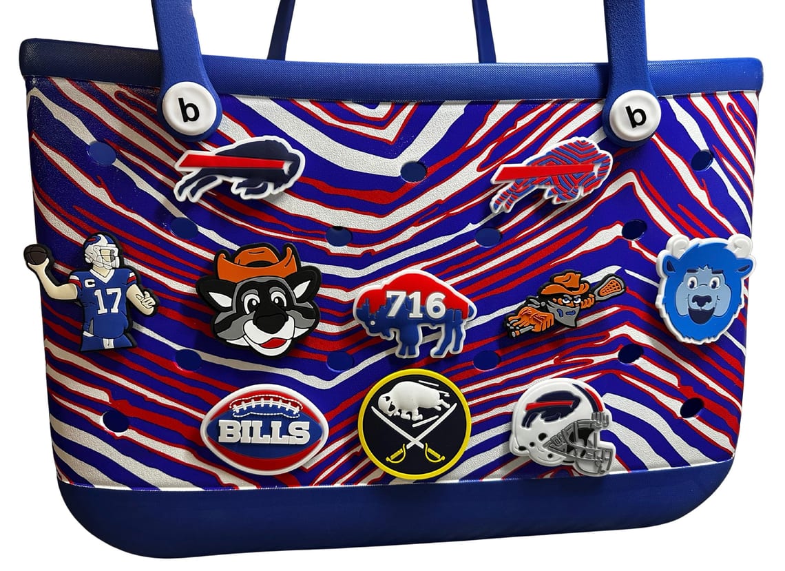 Blue and red striped Bogg Bag covered with a dozen team charms