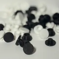 Close-up of screw-on charm backer mechanism showing threaded post