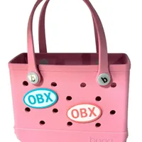 Pink Bogg Bag with two OBX oval charms, one teal and one coral