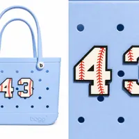 Number charm screwed onto a ballpark tote bag, lifestyle photo